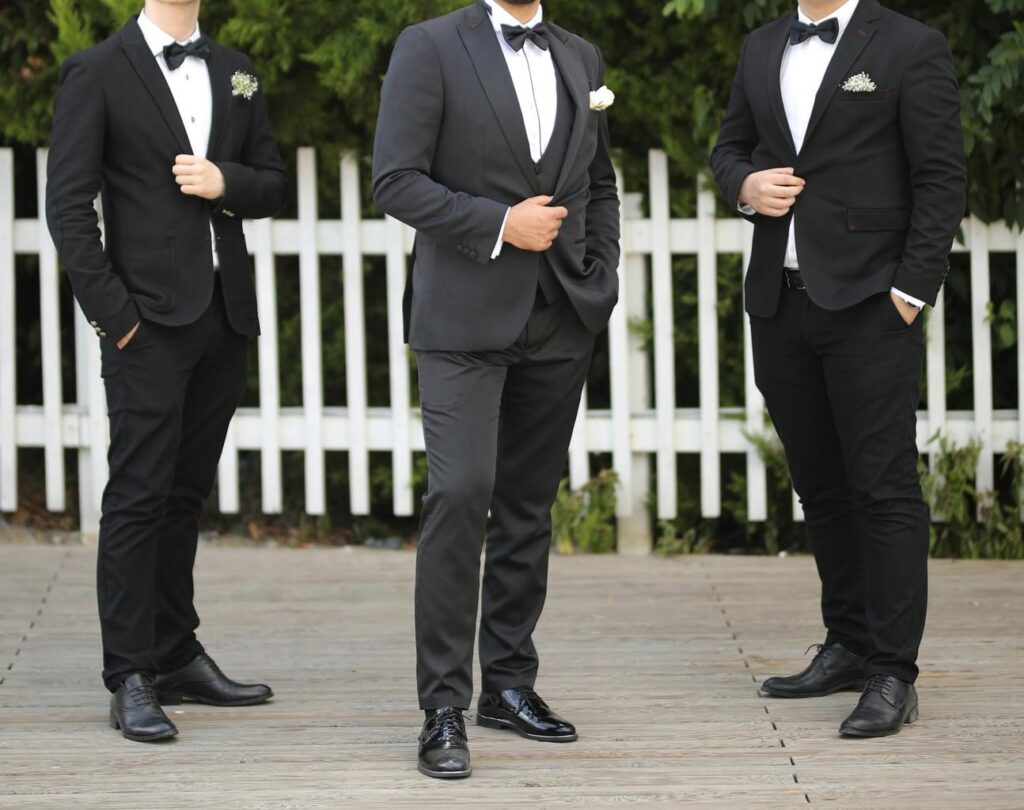 Wedding Season Ready: Wedding Suits for Groom and Groomsmen That Make Men Look Sharp in 2026 Wedding season in 2026 is not just about attending ceremonies — it’s about showing up with style, confidence, and presence. Modern men's fashion has evolved far beyond the traditional black tuxedo. Today, weddings are full of personality, creative venues, and stylish dress codes. Whether you are the groom, a groomsman, or a guest, choosing the right outfit makes a powerful impression. The right wedding suits for groom and groomsmen combine modern tailoring, breathable fabrics, and thoughtful accessories that look incredible both in person and in photos. If you want to step into wedding season looking confident and refined, here are the top outfit trends every man should know in 2026. ________________________________________ Modern Tailored Wedding Suits for Groom and Groomsmen The biggest rule in men’s wedding fashion in 2026 is simple: Fit is everything. The days of oversized, boxy suits are fading. Today’s wedding suits for groom and groomsmen focus on clean tailoring that enhances the natural shape of the body without feeling tight or uncomfortable. A well-tailored suit instantly makes a man look: • More confident • More polished • More stylish Popular colors for groom and groomsmen suits include: • Deep navy • Charcoal grey • Sage green • Beige and sand tones • Classic black for formal weddings Coordinated suits for the groom and groomsmen create a sharp, unified wedding party look that photographs beautifully. ________________________________________ Linen Wedding Suits for Groom and Groomsmen (Perfect for Summer Weddings) Comfort is one of the biggest priorities in 2026 wedding fashion. Many weddings take place outdoors, at beaches, gardens, vineyards, or destination venues. Because of this, lightweight fabrics are becoming essential for wedding suits for groom and groomsmen. Top breathable fabrics include: • Linen • Cotton blends • Lightweight wool • Seersucker Linen suits are especially popular for summer weddings because they provide a relaxed yet elegant look. For example: • Groom in cream or beige linen suit • Groomsmen in light tan or soft blue linen suits This creates a stylish but natural wedding aesthetic. ________________________________________ Statement Blazers for Stylish Grooms 4 While groomsmen often wear coordinated suits, the groom can stand out with a statement blazer. This is a growing trend in 2026 groom fashion. Popular statement blazer styles include: • Floral jacquard patterns • Velvet evening jackets • Deep jewel tones like emerald or burgundy • Subtle textured fabrics This allows the groom to remain visually distinct while still matching the wedding party. ________________________________________ Smart Casual Wedding Looks for Modern Weddings 4 Not every wedding in 2026 requires a full suit. Many couples now prefer relaxed, outdoor, or destination weddings. For these settings, smart casual outfits work perfectly for groomsmen or wedding guests. A stylish smart-casual wedding look might include: • A tailored blazer • Crisp dress shirt • Slim chinos or trousers • Leather loafers or dress shoes This style looks intentional and polished while staying comfortable. ________________________________________ Accessories That Complete Groom and Groomsmen Looks 4 Accessories bring personality to wedding suits for groom and groomsmen. Small details can elevate the entire outfit. Popular wedding accessories include: • Pocket squares • Matching ties or bow ties • Boutonnières (lapel flowers) • Elegant watches • Stylish sunglasses for outdoor ceremonies The key is balance — accessories should enhance the outfit without overpowering it. ________________________________________ Grooming: The Secret to Looking Sharp Even the most expensive suit cannot replace good grooming. Before the wedding day, every groom and groomsman should focus on: • A clean haircut • Trimmed facial hair • Polished shoes • Fresh, subtle fragrance • Well-pressed suits These small details ensure the entire wedding party looks sharp, confident, and photo-ready. ________________________________________ Final Thoughts Wedding fashion in 2026 blends timeless elegance with modern style. From breathable linen fabrics to perfectly tailored jackets, today’s wedding suits for groom and groomsmen allow men to look sharp while staying comfortable throughout the celebration. The goal isn’t just to dress up — it’s to show up looking confident, stylish, and ready to celebrate one of life’s most important moments. Because when the suits fit well, the details are right, and the confidence shows… You don’t just attend the wedding. You arrive. 